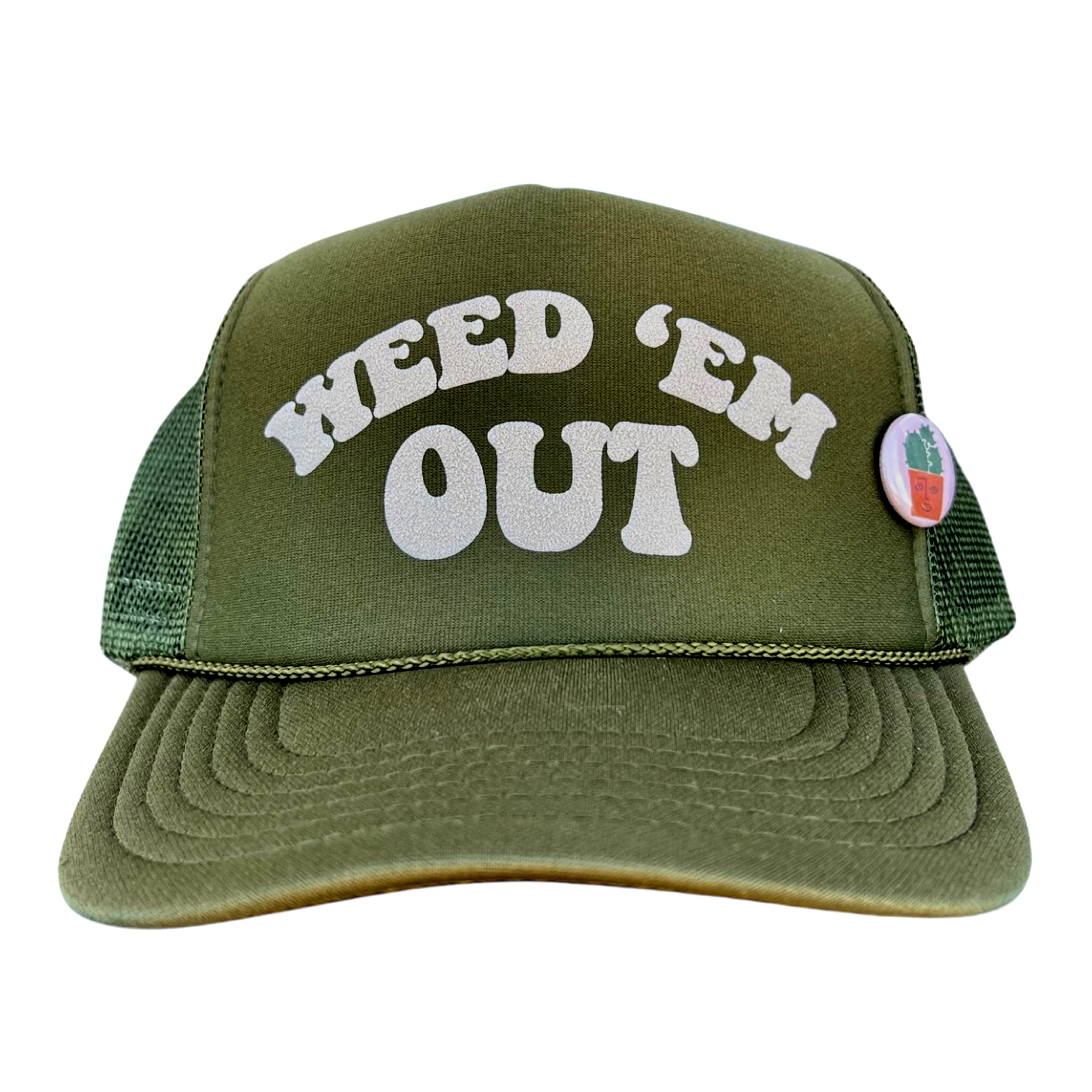 An olive green trucker hat with the text 'WEED 'EM OUT' in white letters on the front and a small pin with a plant illustration on the left side.